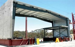 metal building with heavily loaded mezzanine and concrete sidewalls