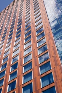 A combination of custom coatings supplied by Valspar Corp. replicated the appearance of weathered steel on the JW Marriott Convention Center Hotel.