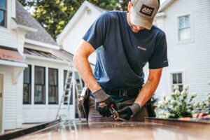 Tony Blue, Squared Away Contracting, Saratoga, N.Y., uses snips to make easy, controlled cuts on metal roofing material