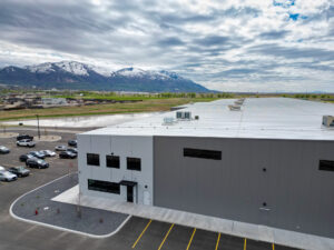 Exterior of Metl-Span’s IMP manufacturing facility in the foreground with mountains in the background.