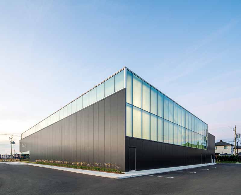 The exterior of an aquatic center fitted with insulated metal panels. 