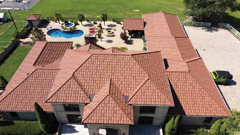 Courtesy Westlake Royal Building Products A stone-coated roof system no a large home.