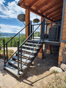  A steel deck stair system attached to a wooden deck. 