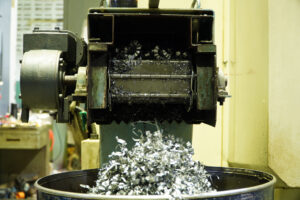  Aluminum chip waste after machining metal parts on a CNC lathe. 