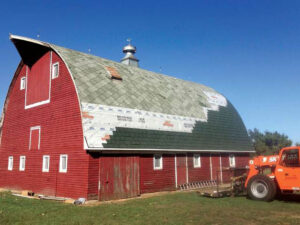 a red barn with a tractor in the back