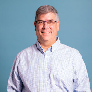 a man wearing glasses and a white shirt