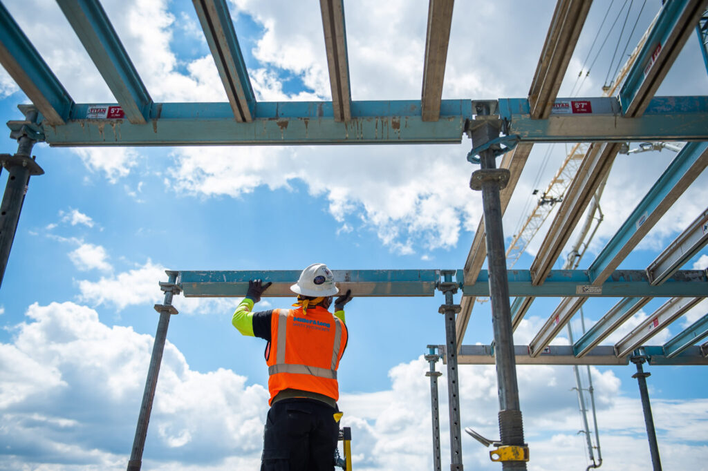 a construction worker assembles a building component