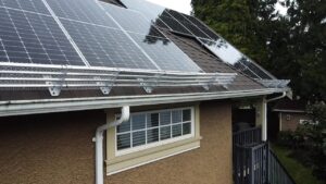Courtesy Rocky Mountain Snow Guards A home with a roof featuring solar panels and an aluminum snow retention system.