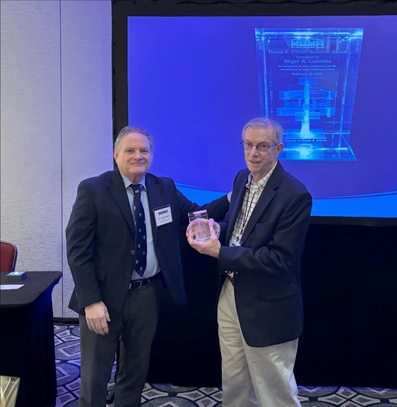 Photo courtesy Metal Building Manufacturers Association Two men, Dr. Roger A. LaBoube, and Dr. Lee Shoemaker, stand for a photo.