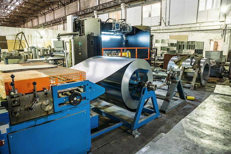 metal coil going through manufacturing equipment