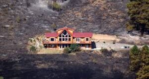 The aftermath after a fire in a building with a metal roof. 