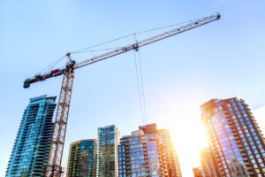 Construction crane in downtown Vancouver at sunrise, representing abandonments.
