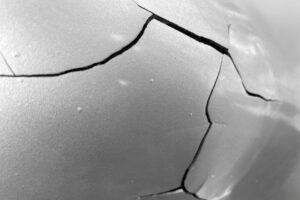 Photo (c) Valeriy Volkonskiy/Getty Images bursting and exploding sheet of metal. cracks in metal.