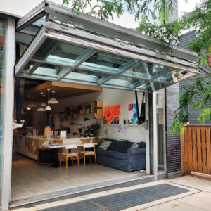 A store front with an open bifold door. 