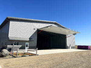 A metal building with a hydraulic door. 