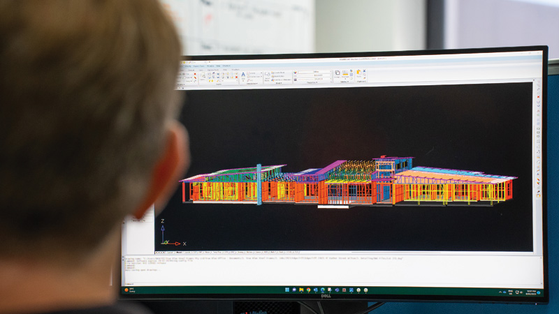 A man using DfMA technology in building construction design. 