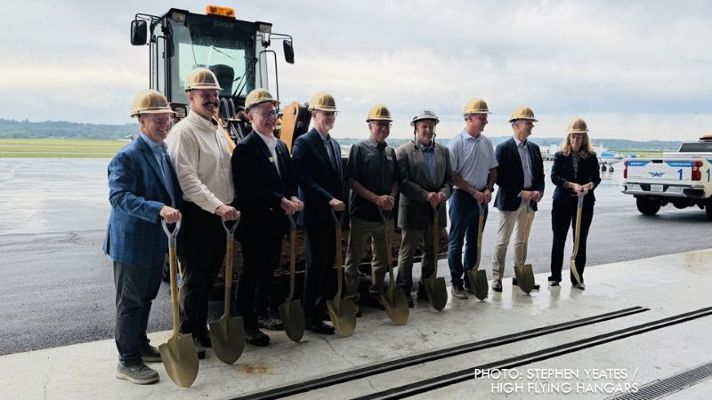 A group poses with shovels during a groundbreaking ceremony at Frederick Municipal Airport.