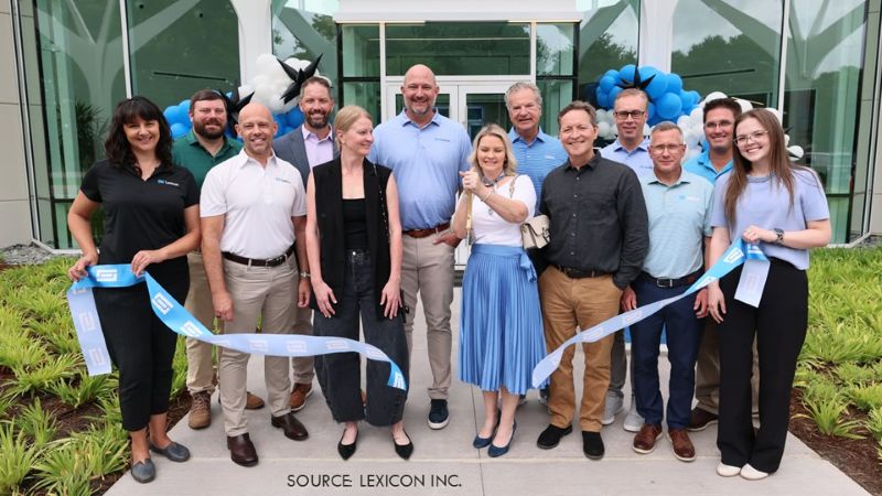 A group poses with a ribbon outside Lexicon’s renovated headquarters.