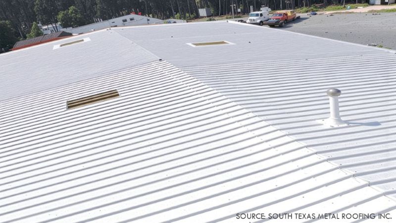 White-coated corrugated metal roof with several roof openings and a vent pipe.